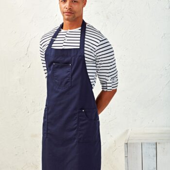 Ολόσωμη Ποδιά Με Τσέπες PR132 'CHINO' από 100% βαμβάκι Twill με μεταλλικό σύνδεσμο και τρεις τσέπες.